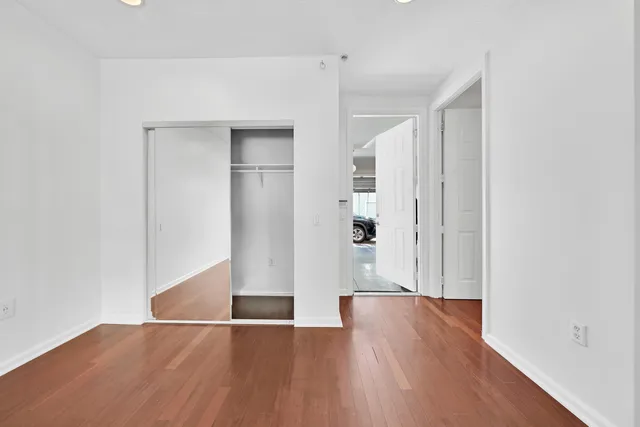 a view of hallway with sink and wooden floor