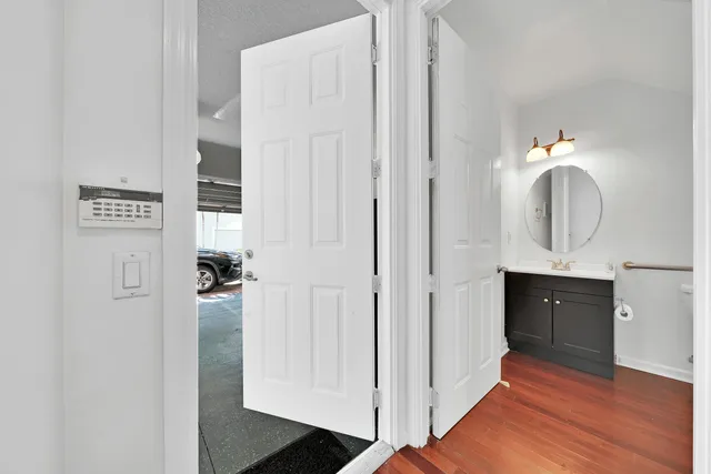 a bathroom with a toilet sink and mirror