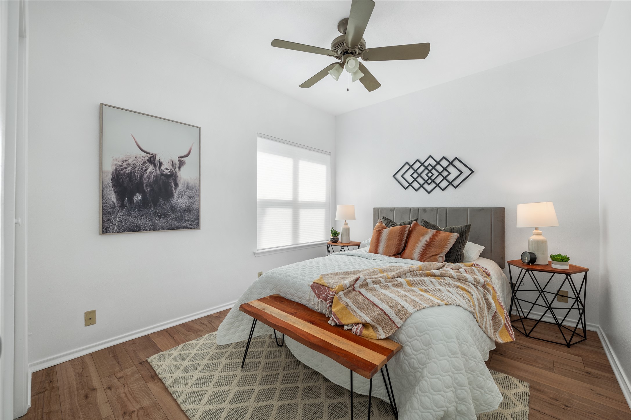 2414 Longview Street, Unit 101 Austin, TX 78705 - Photo 16 of 31 a bedroom with a bed and a chandelier