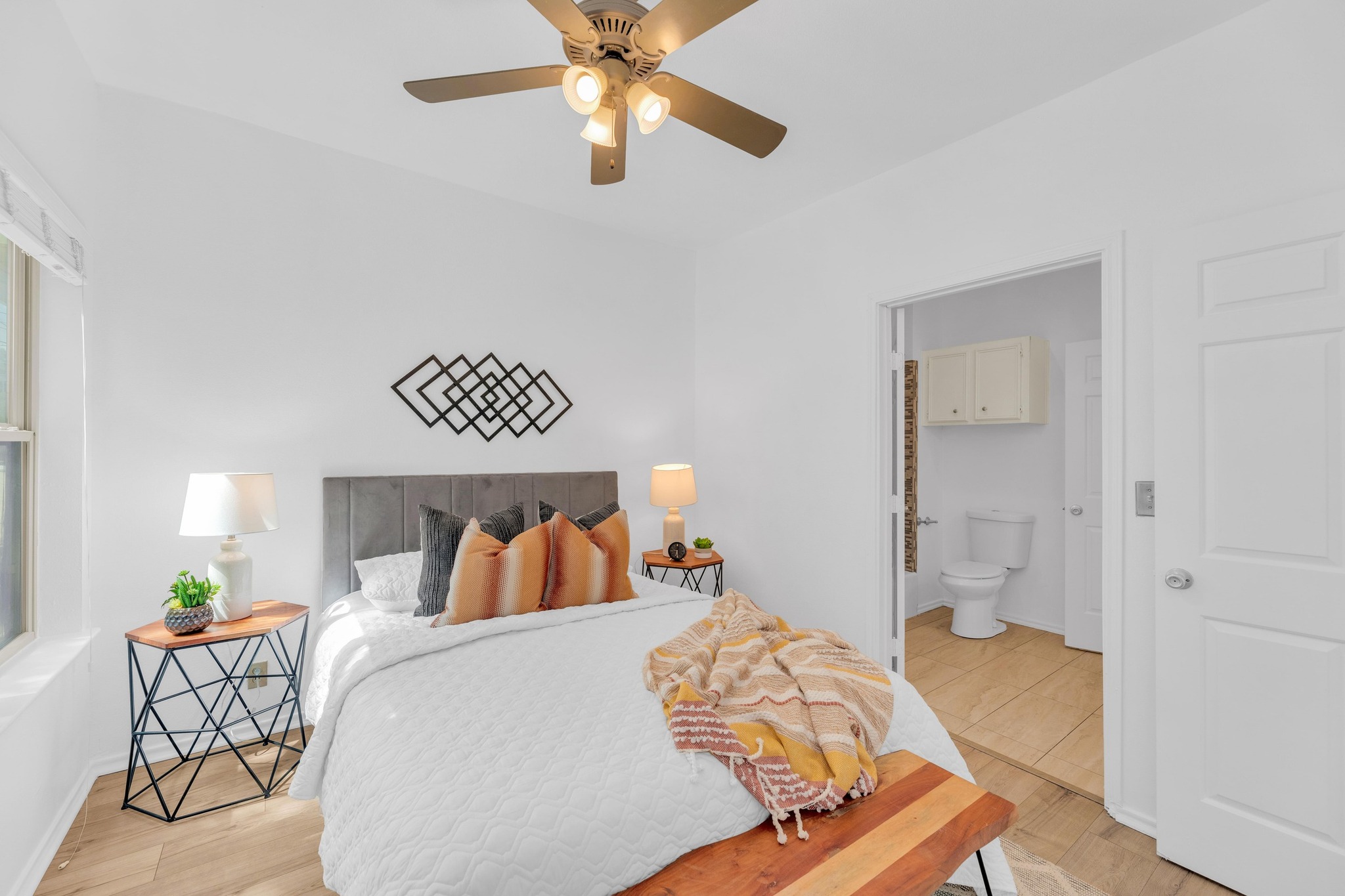 2414 Longview Street, Unit 101 Austin, TX 78705 - Photo 17 of 31 a bedroom with a bed and a chandelier