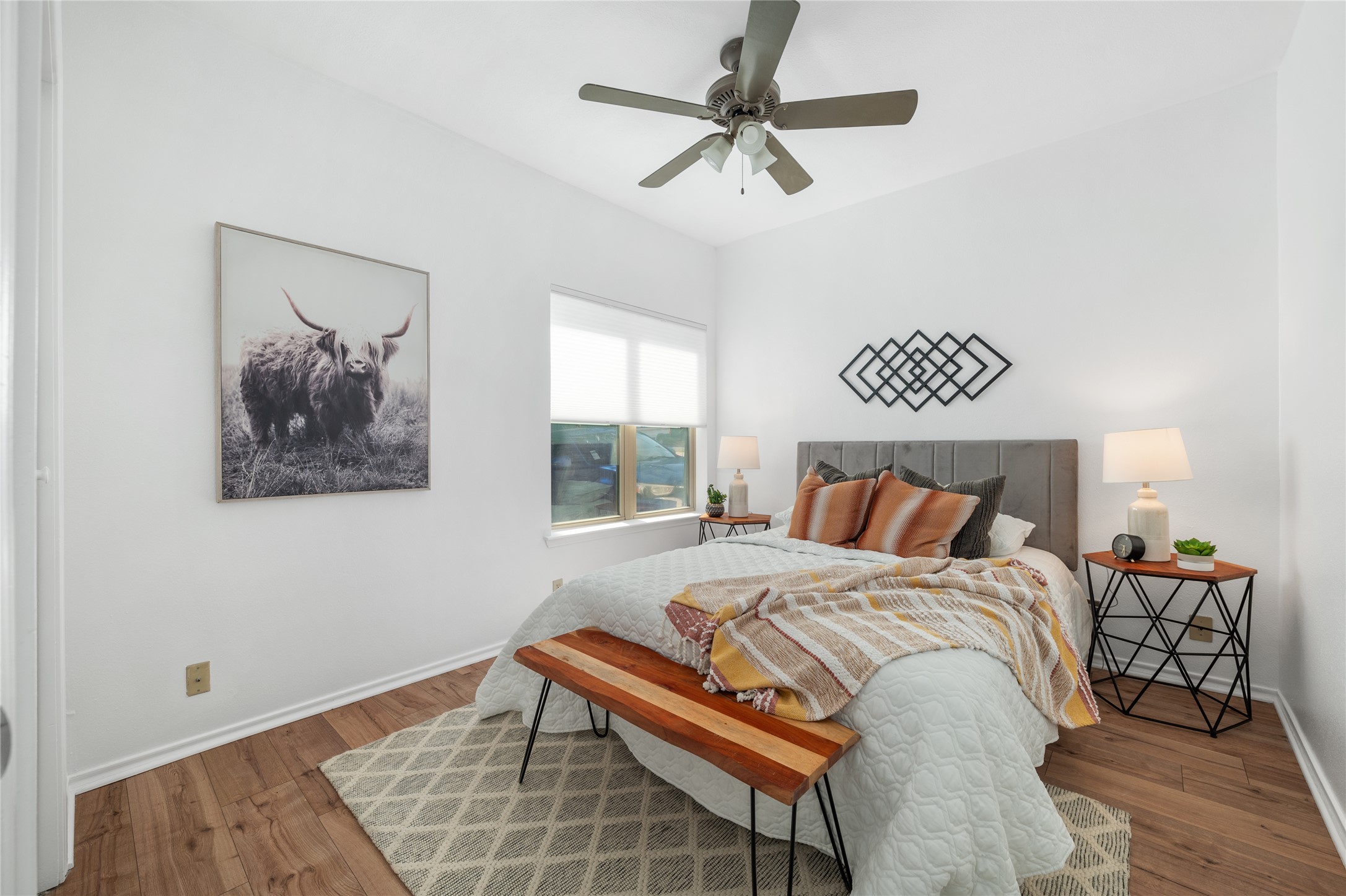 2414 Longview Street, Unit 101 Austin, TX 78705 - Photo 18 of 31 a bedroom with a bed and a chandelier