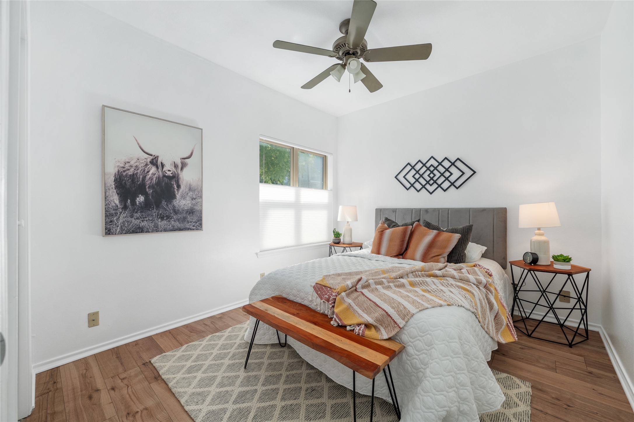 2414 Longview Street, Unit 101 Austin, TX 78705 - Photo 19 of 31 a bedroom with a bed and a chandelier