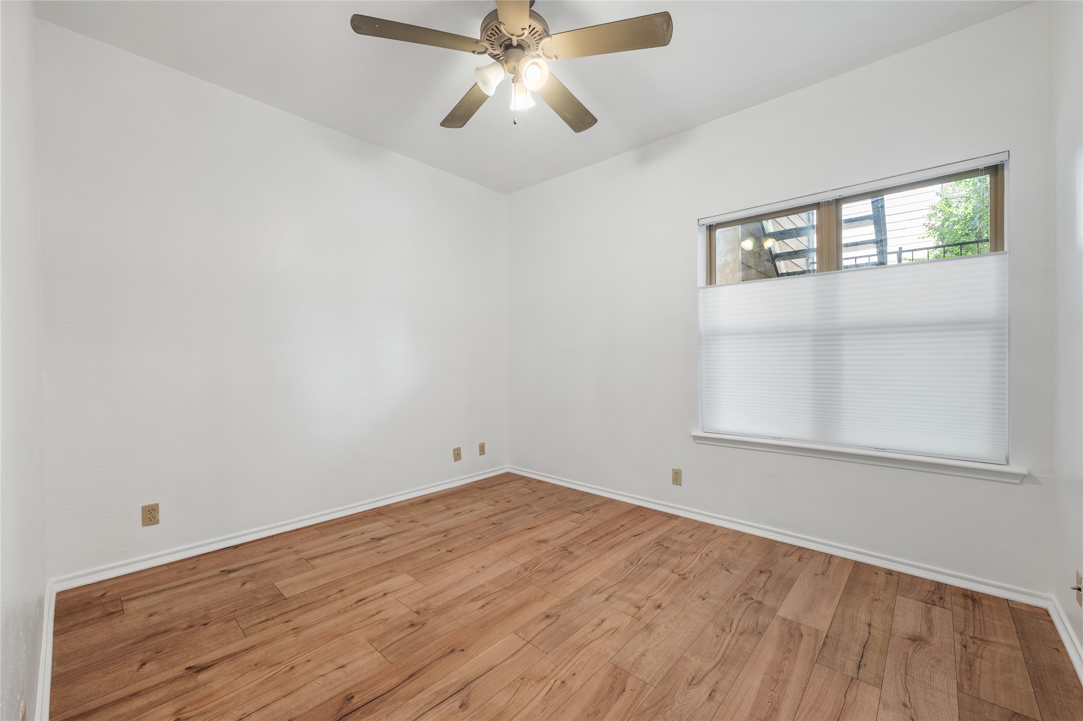 2414 Longview Street, Unit 101 Austin, TX 78705 - Photo 24 of 31 an empty room with windows and fan