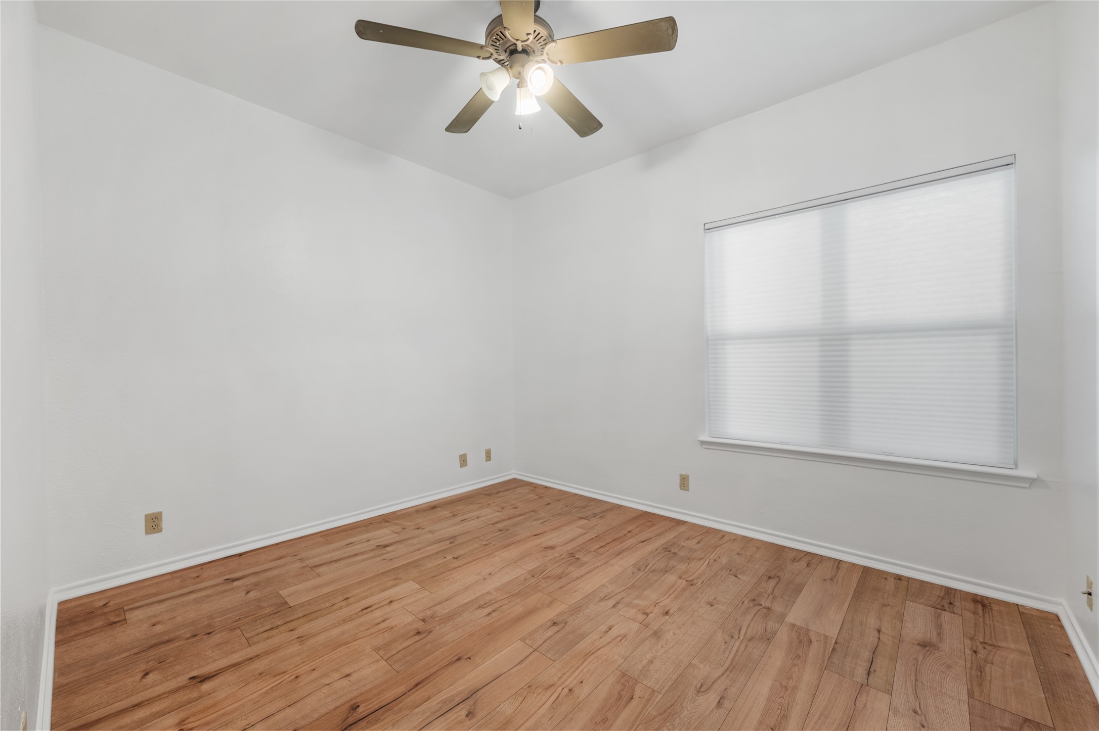 2414 Longview Street, Unit 101 Austin, TX 78705 - Photo 25 of 31 an empty room with a window and ceiling fan