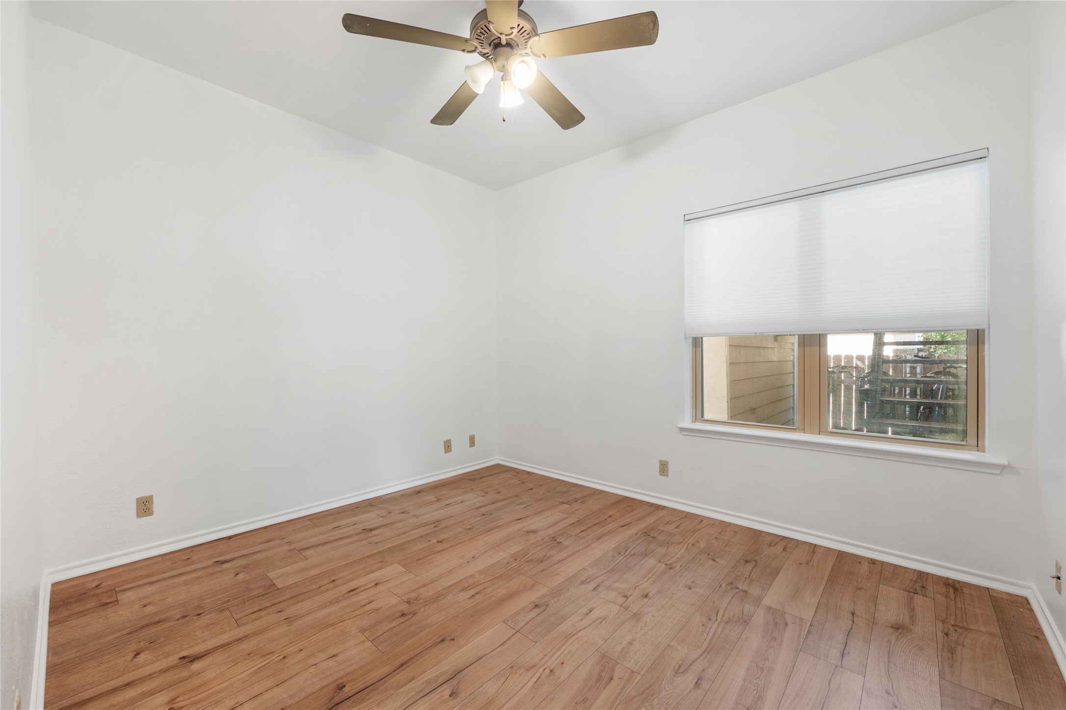 2414 Longview Street, Unit 101 Austin, TX 78705 - Photo 26 of 31 wooden floor in an empty room with a window