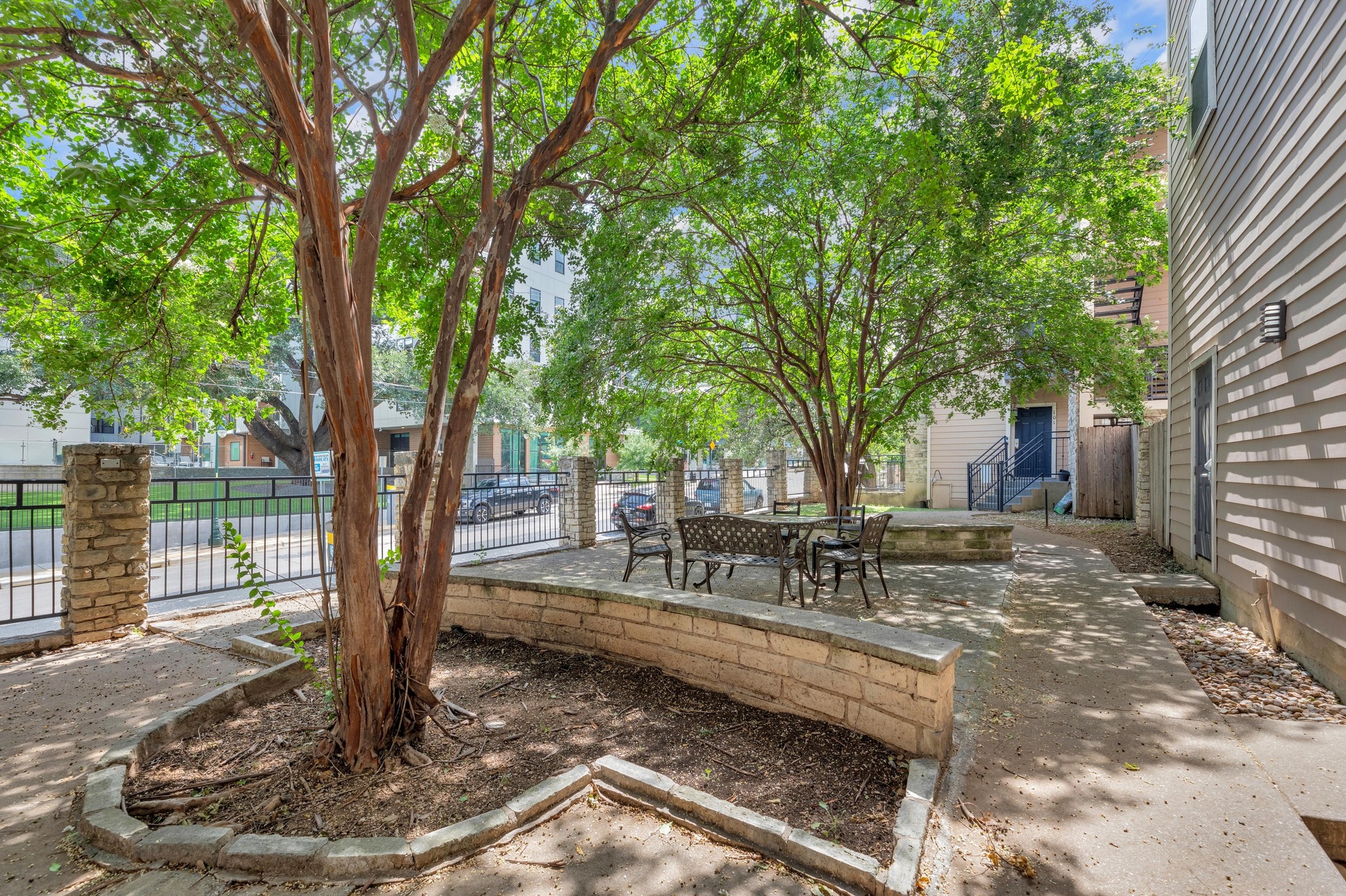 2414 Longview Street, Unit 101 Austin, TX 78705 - Photo 29 of 31 a view of a backyard with large trees and wooden fence