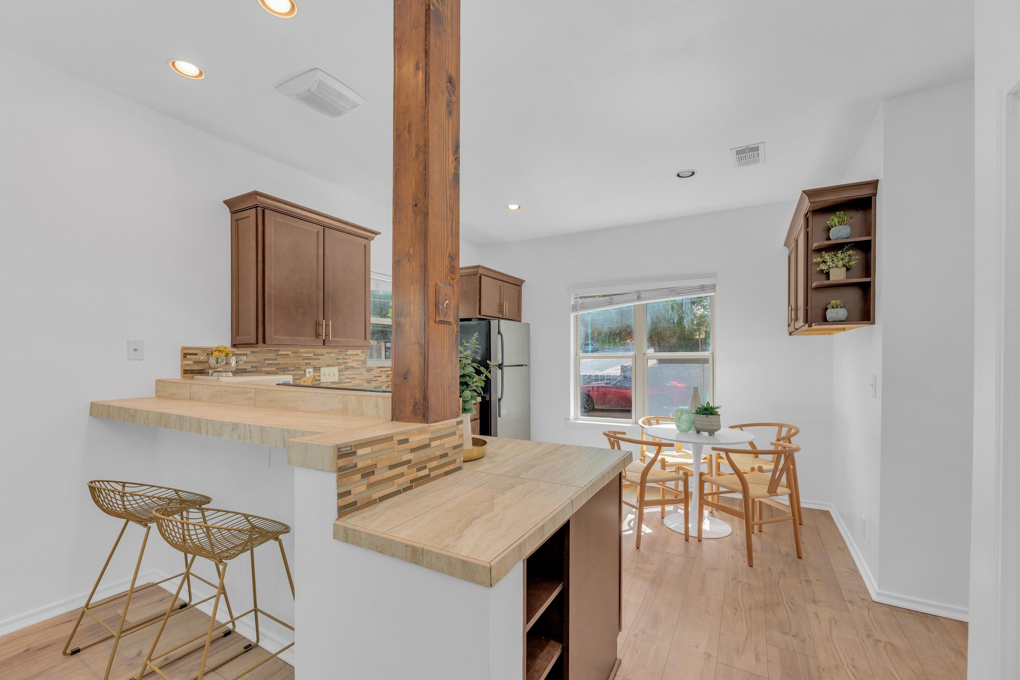 2414 Longview Street, Unit 101 Austin, TX 78705 - Photo 8 of 31 a kitchen with a table chairs and a refrigerator