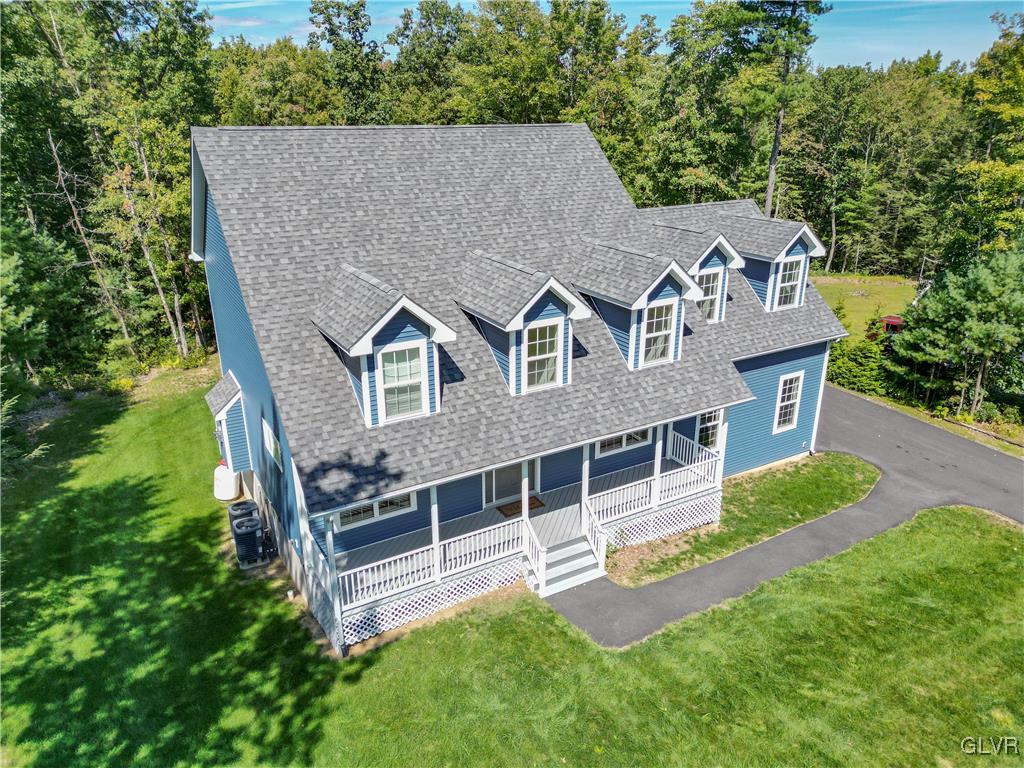 an aerial view of a house with a yard