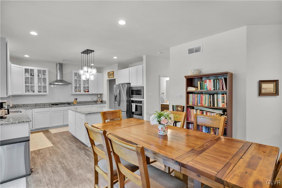 152 Corktree Road Kunkletown, PA 18058 - Photo 13 of 49 a kitchen with stainless steel appliances kitchen island granite countertop a dining table chairs and refrigerator