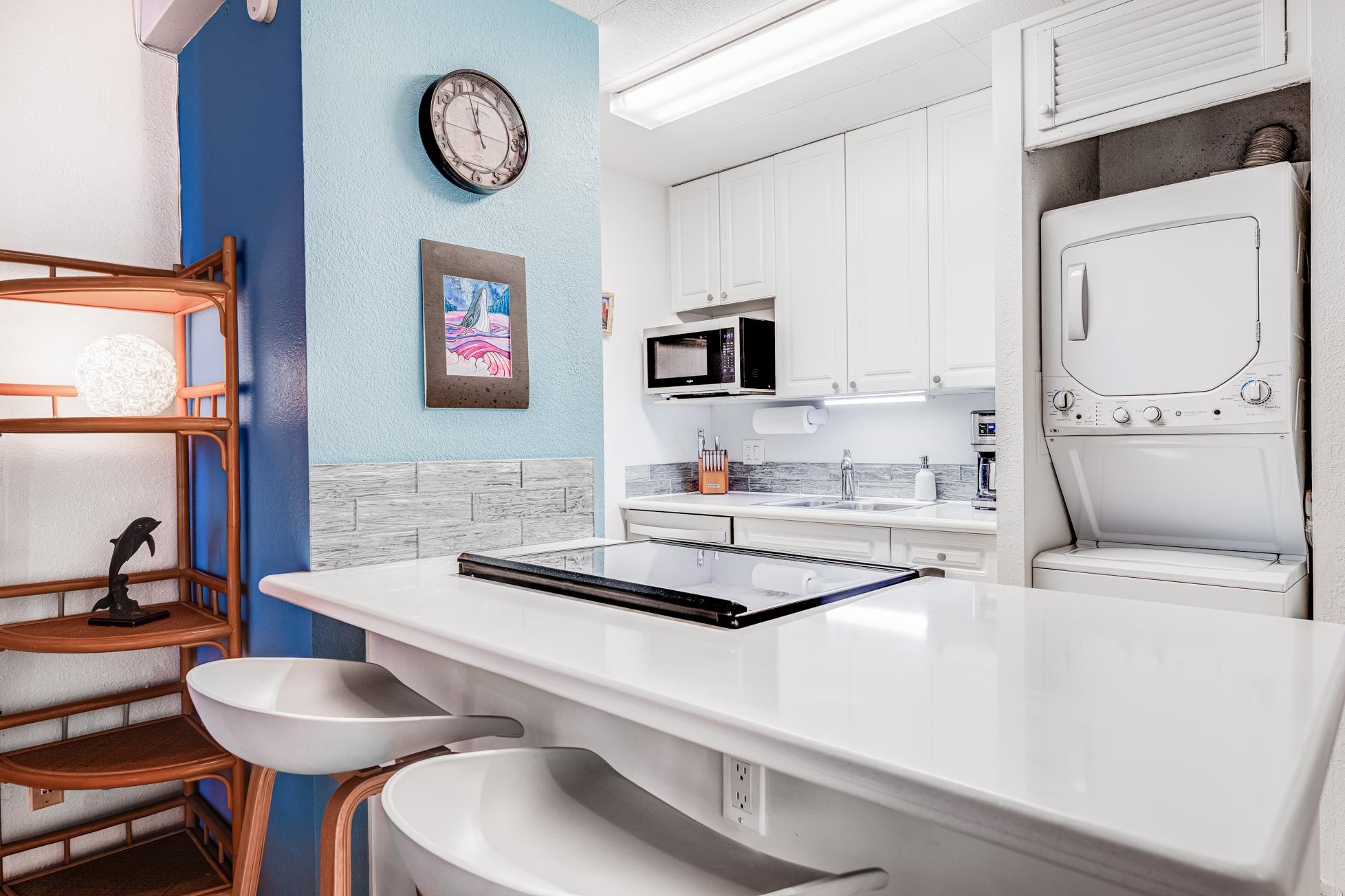 2191 South Kihei Road, Unit 3402 Kihei, HI 96753 - Photo 14 of 50 a kitchen with stainless steel appliances a stove a sink and a refrigerator with wooden floor
