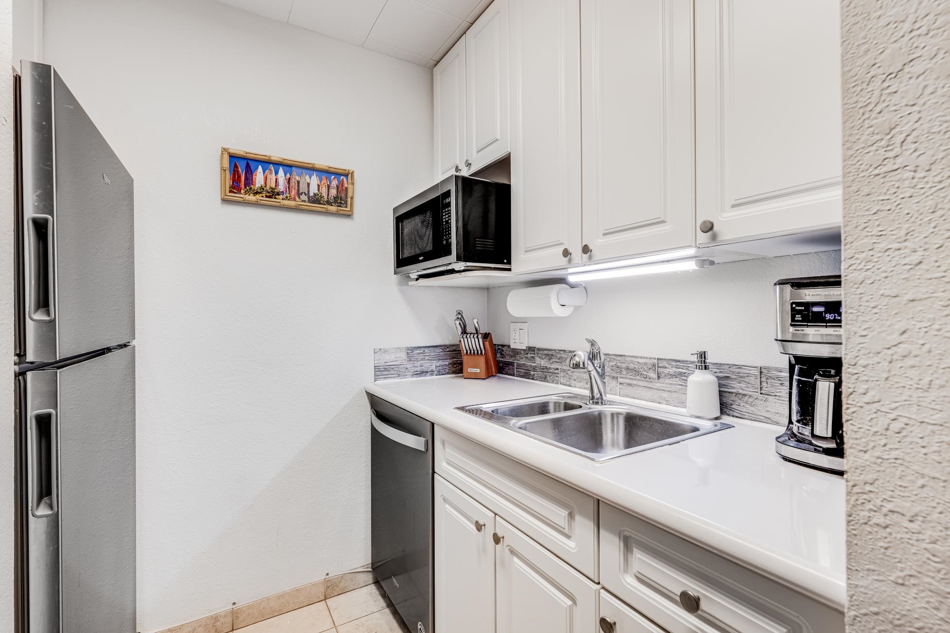 2191 South Kihei Road, Unit 3402 Kihei, HI 96753 - Photo 15 of 50 a kitchen with stainless steel appliances granite countertop a sink and a refrigerator