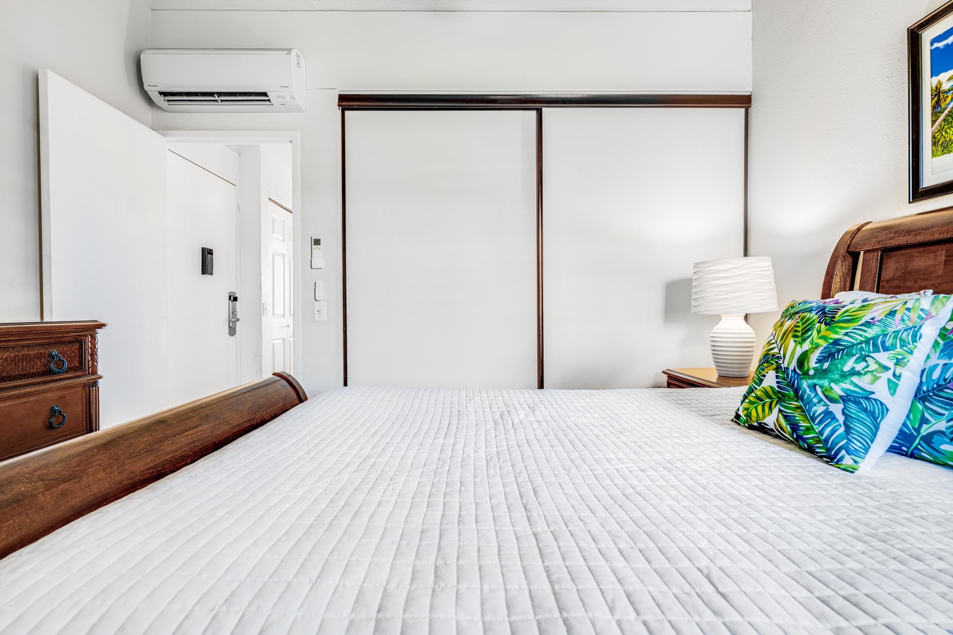 2191 South Kihei Road, Unit 3402 Kihei, HI 96753 - Photo 24 of 50 a bedroom with a bed table and a potted plant