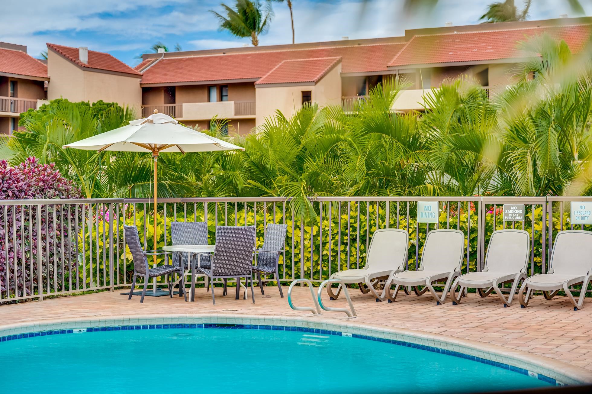 2191 South Kihei Road, Unit 3402 Kihei, HI 96753 - Photo 34 of 50 a view of a chairs and table in patio with a small yard