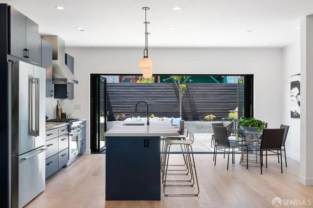 a living room with furniture a fireplace and a potted plant