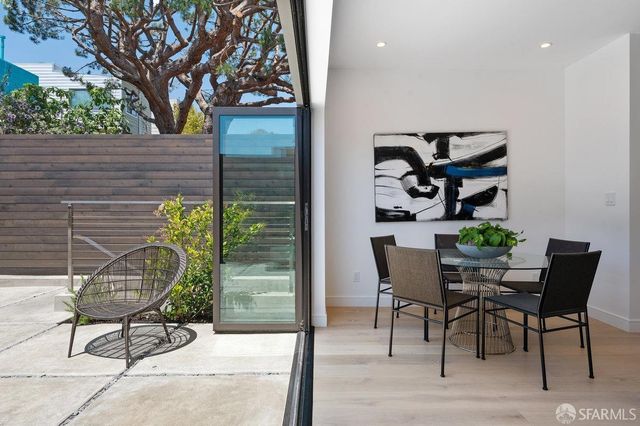 a view of a workspace room with a window and furniture