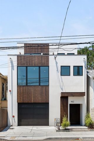 a living room with furniture kitchen view and a large window