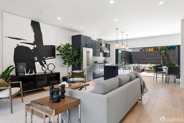a living room with furniture and a potted plant