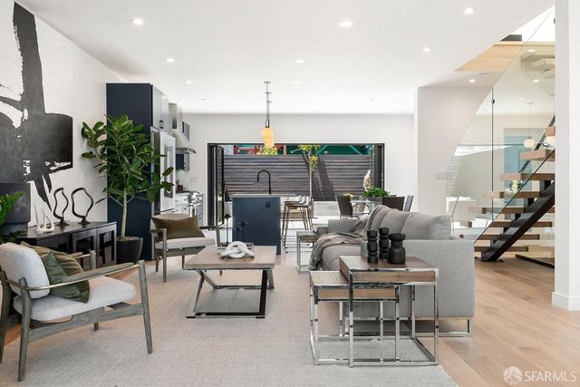 a living room with fireplace furniture and a potted plant