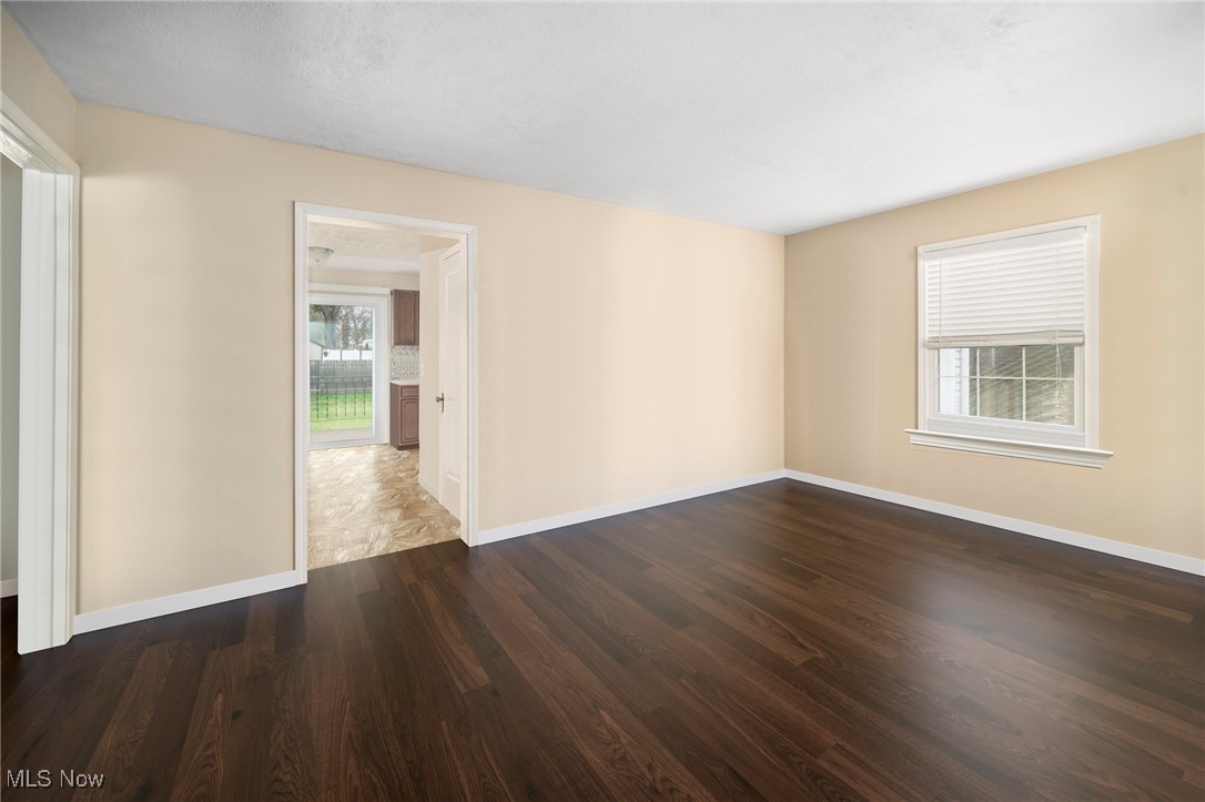 187 Everhard Road Southwest North Canton, OH 44720 - Photo 4 of 19 Unfurnished room featuring baseboards and wood finished floors