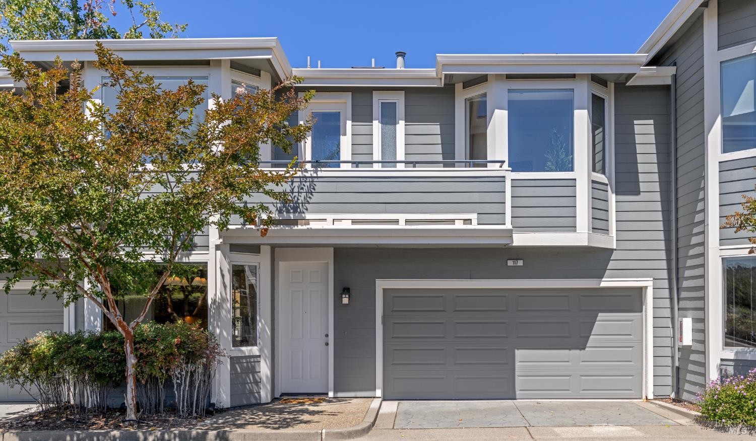 a front view of a house with plants