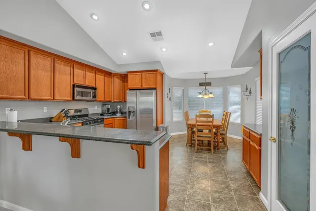 a view of a dining room with furniture and window