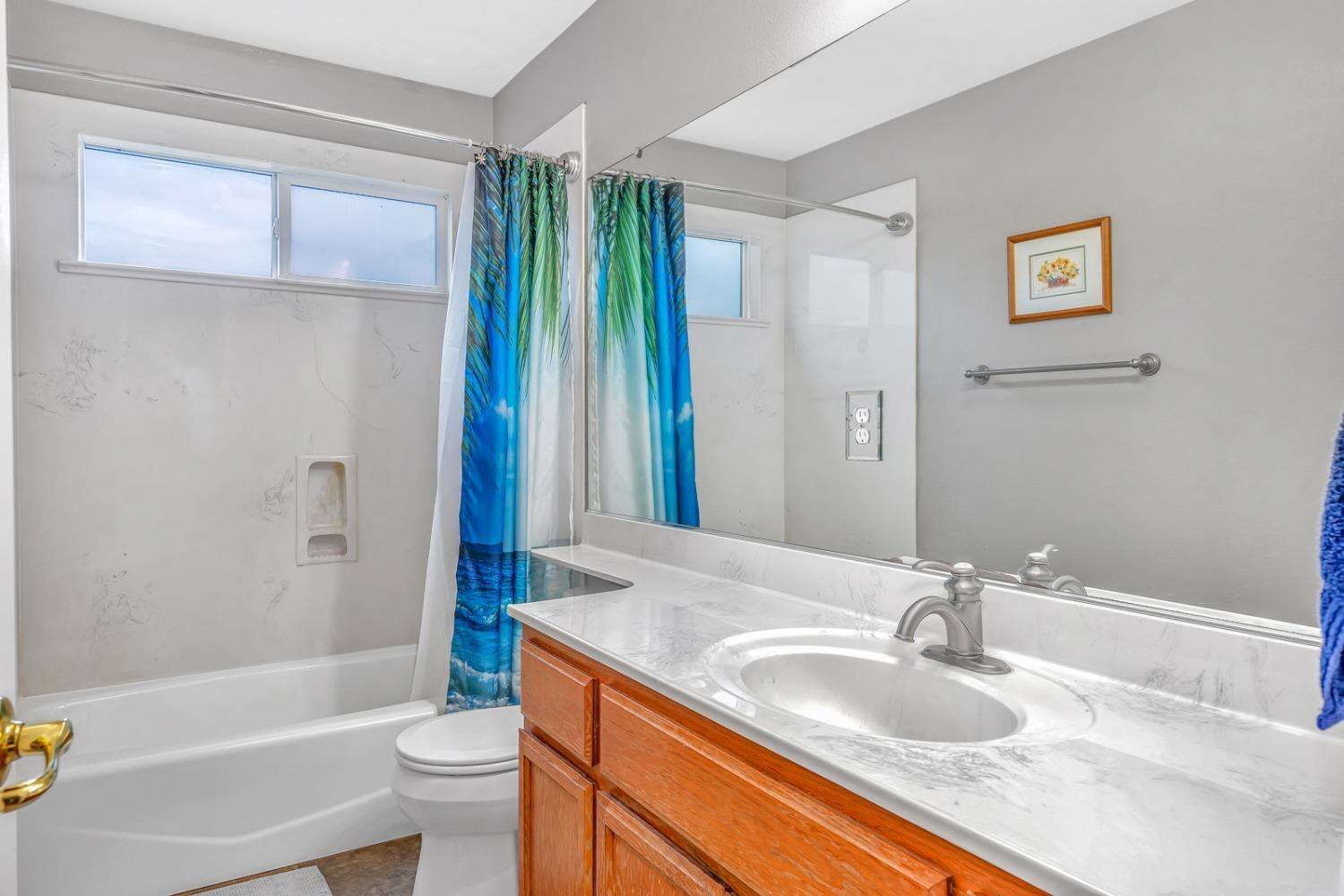 14155 Buchanan Hollow Road Le Grand, CA 95333 - Photo 31 of 46 a bathroom with a granite countertop sink toilet and shower
