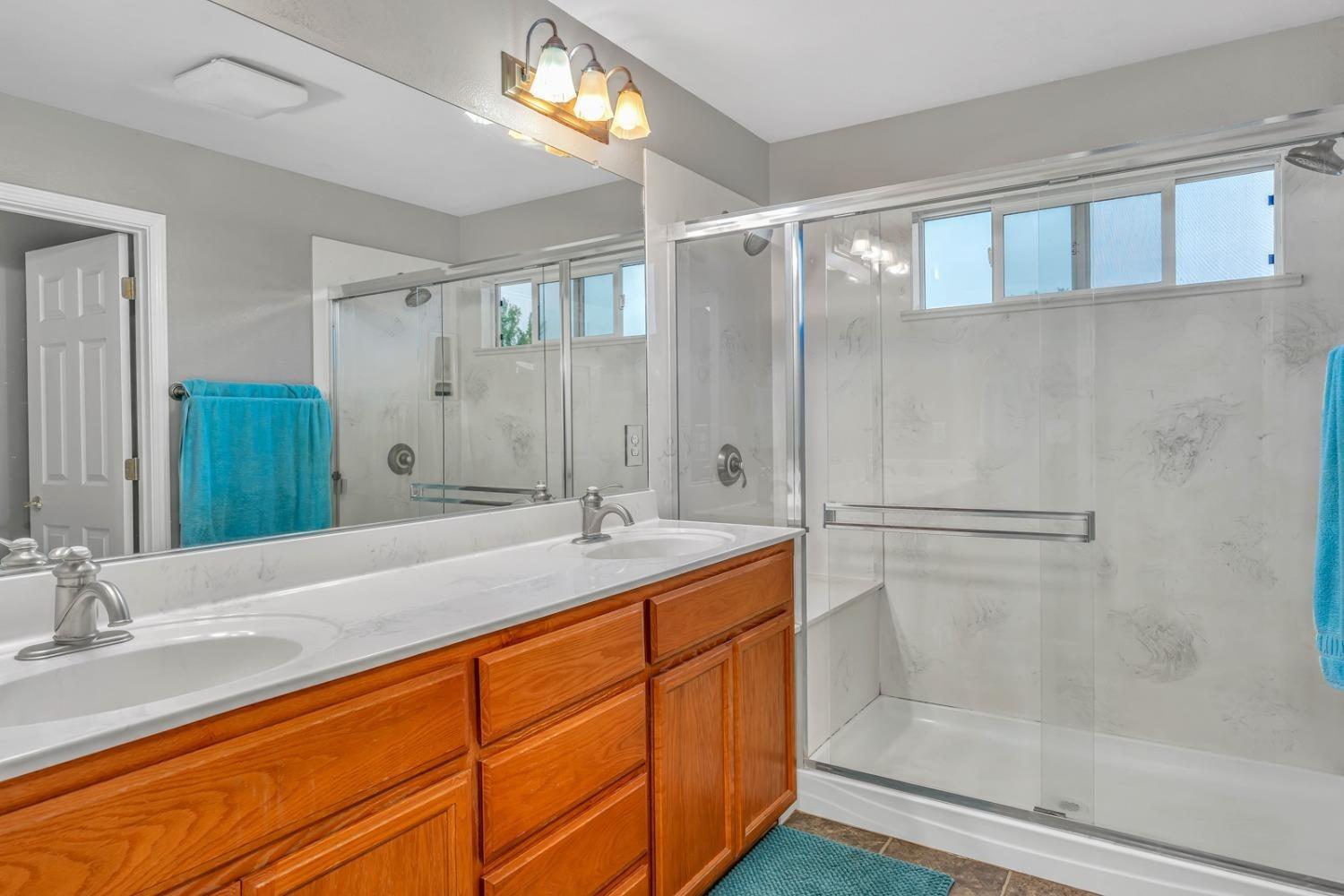 14155 Buchanan Hollow Road Le Grand, CA 95333 - Photo 37 of 46 a bathroom with a granite countertop sink mirror and double