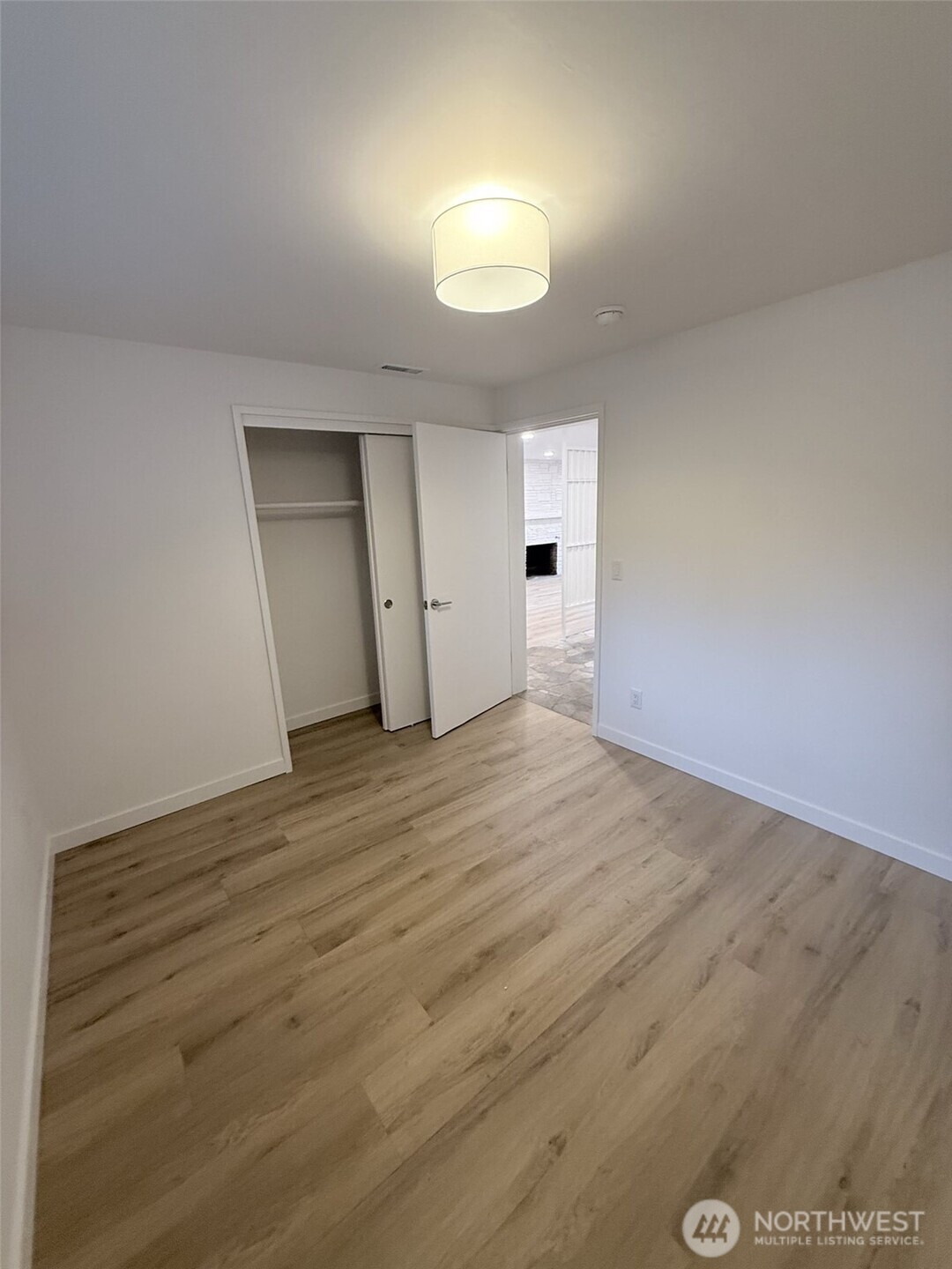 13936 4th Avenue Southwest, Unit A Burien, WA 98166 - Photo 12 of 14 an empty room with wooden floor and windows