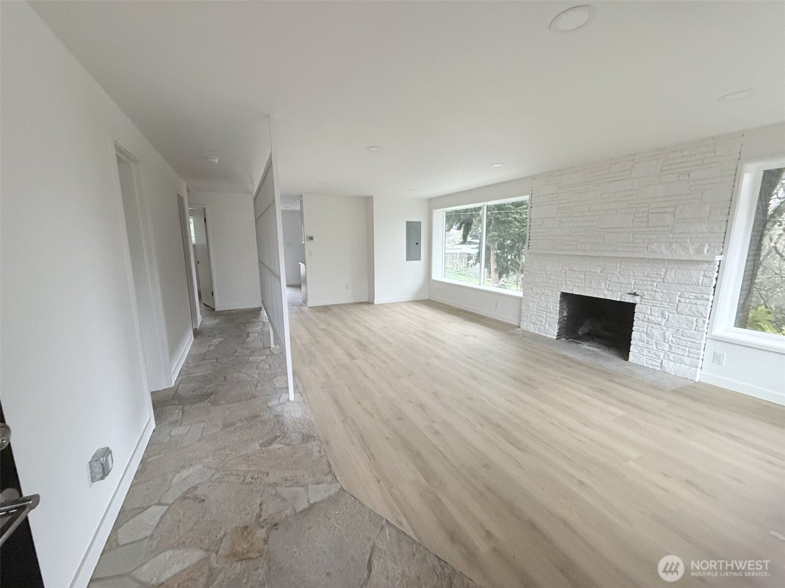 13936 4th Avenue Southwest, Unit A Burien, WA 98166 - Photo 3 of 14 an empty room with wooden floor and windows