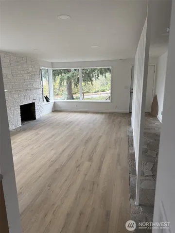 wooden floor in an empty room with a fireplace