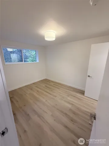 a view of a room with wooden floor and staircase