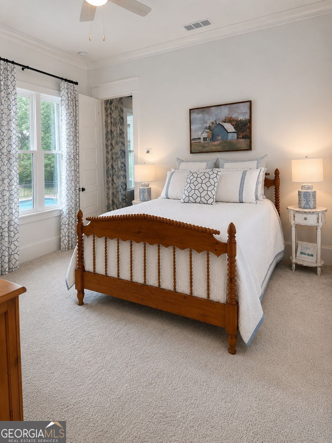 913 Indigo Bunting Road Statham, GA 30666 - Photo 19 of 31 a bed sitting in a bedroom next to a window