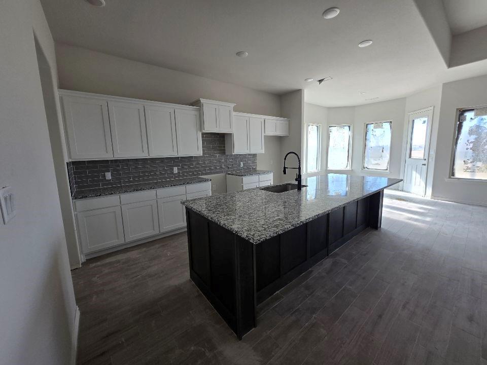 118 Hillview Trail Decatur, TX 76234 - Photo 10 of 22 a kitchen with granite countertop sink and cabinets