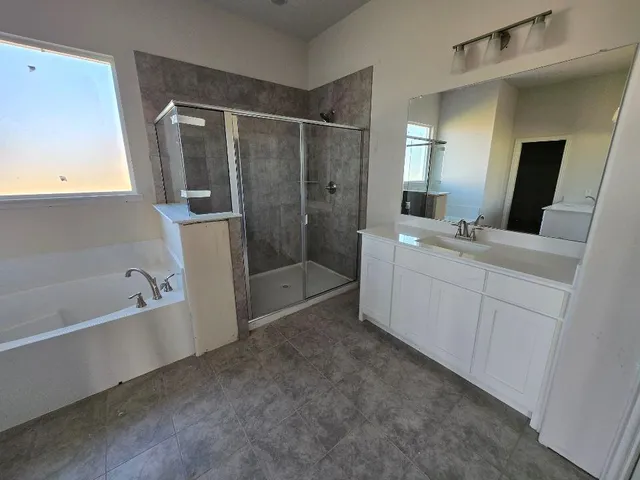a bathroom with a bathtub sink and mirror
