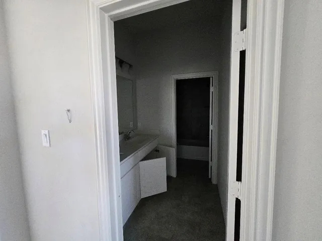 a view of a bathroom from a hallway