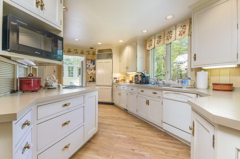 135 Witherow Road Sewickley, PA 15143 - Photo 4 of 25 With double windows over the sink, there is a great view of the mature landscaping and wildlife in the area.Doorway in rear leads to laundry, powder room and access to rear deck.