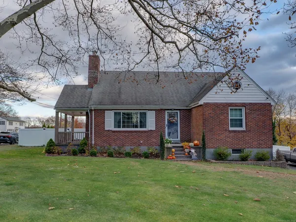 a front view of a house with a garden