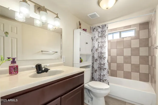 a bathroom with a sink a toilet a shower and a mirror