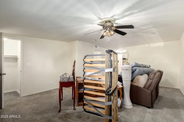 a view of a livingroom with furniture and a ceiling fan