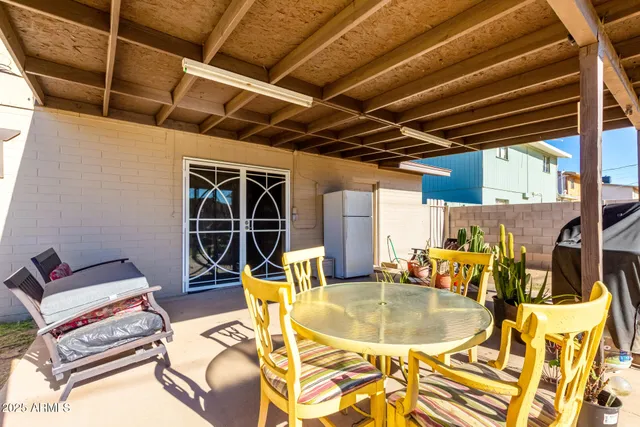 a view of a swimming pool with a dining table and chairs