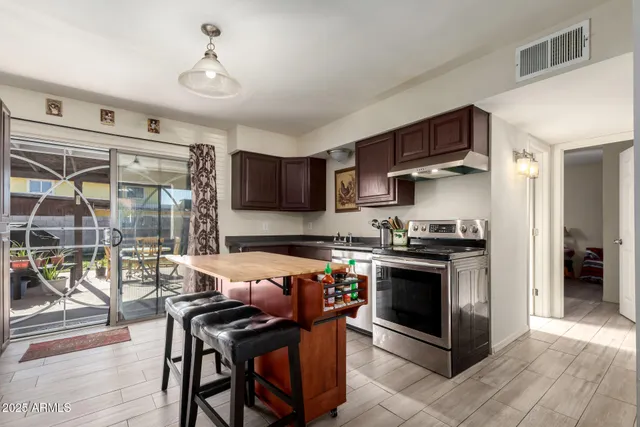 a kitchen with stainless steel appliances granite countertop a stove and a sink