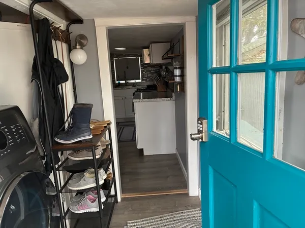 a view of a hallway with entryway and furniture