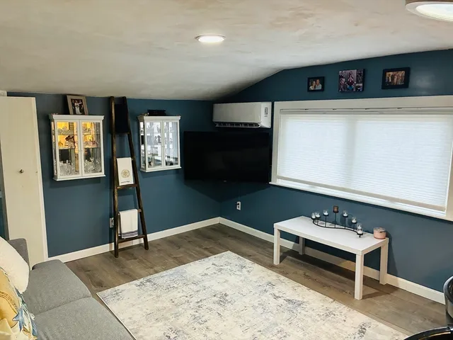 a living room with furniture a rug and a wooden floor