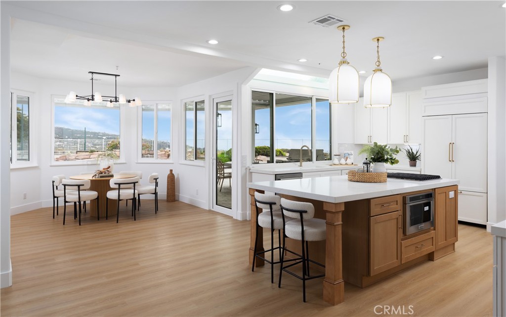 2001 Via Aguila San Clemente, CA 92673 - Photo 13 of 53 a kitchen with kitchen island a dining table and a chandelier