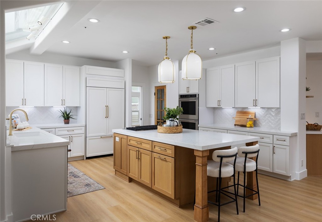 2001 Via Aguila San Clemente, CA 92673 - Photo 14 of 53 a kitchen with a sink a center island cabinets and stainless steel appliances