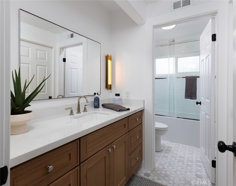 2001 Via Aguila San Clemente, CA 92673 - Photo 24 of 53 a bathroom with a granite countertop sink a toilet and mirror