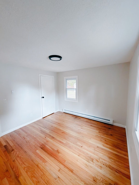 206 Treetop Avenue Springfield, MA 01118 - Photo 10 of 16 a view of empty room with wooden floor and fan