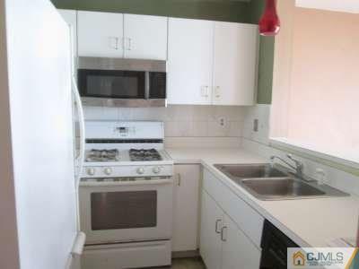 819 Edpas Road New Brunswick, NJ 08901 - Photo 5 of 6 a kitchen with a sink stove and microwave