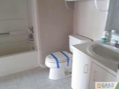 819 Edpas Road New Brunswick, NJ 08901 - Photo 6 of 6 a bathroom with a sink and a toilet