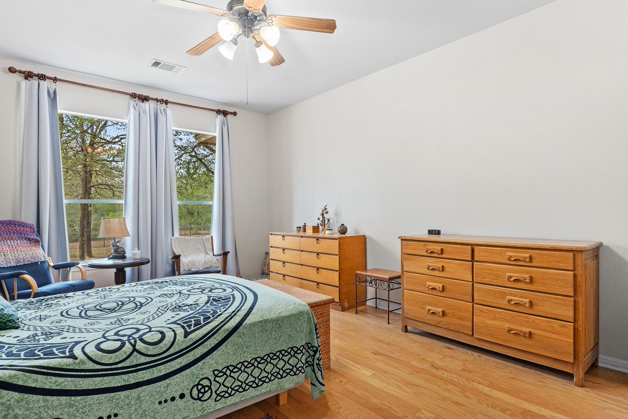 202 The Oaks Boulevard Elgin, TX 78621 - Photo 21 of 40 Bedroom with light wood finished floors and ceiling fan